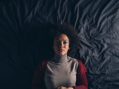 Top View of a Beautiful Woman Lying in Bed 