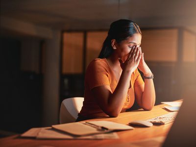 stressed person with hands on their face