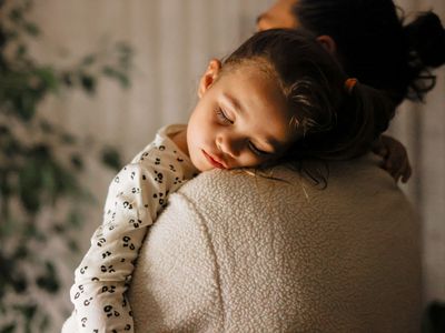 kid on her parent's shoulder