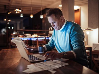 Mature man going over his finances in the evening