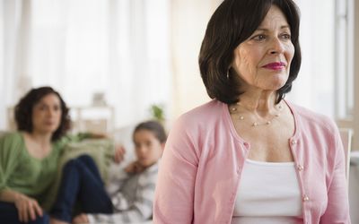 Serious woman with family in background