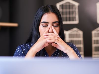 person stressed out with hands on their face