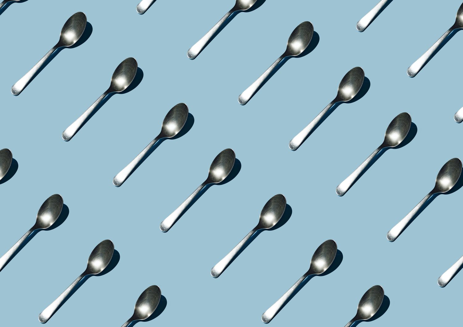 Seamless pattern of teaspoon on blue background