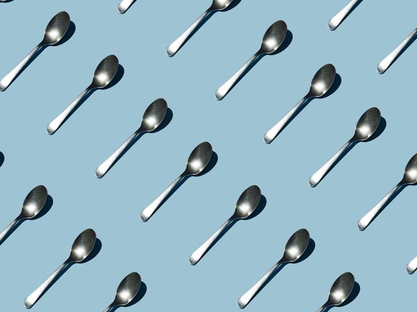 Seamless pattern of teaspoon on blue background