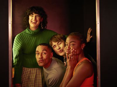 Portrait of female and male friends making faces inside photo booth