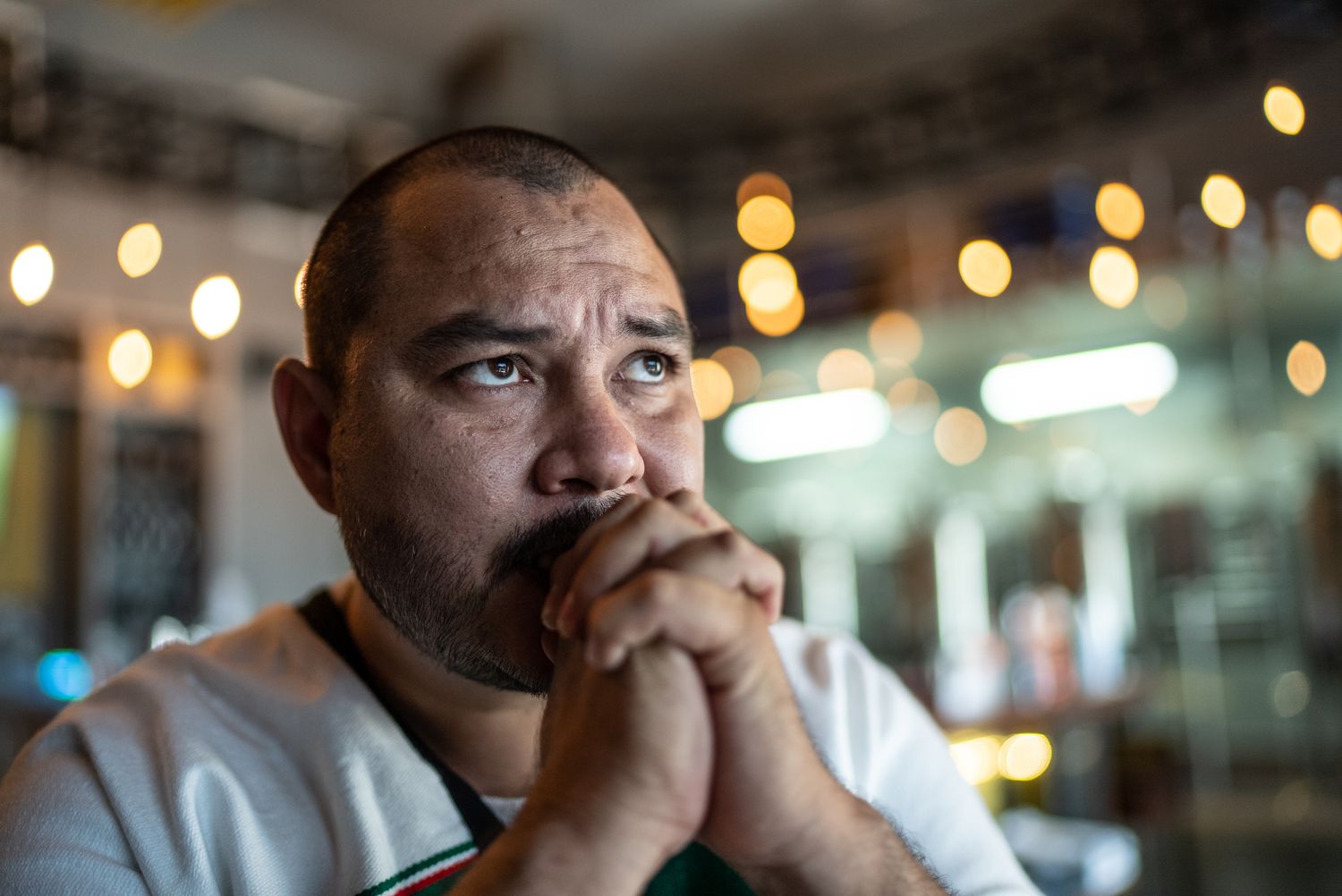 Mid adult man watching a soccer game at bar