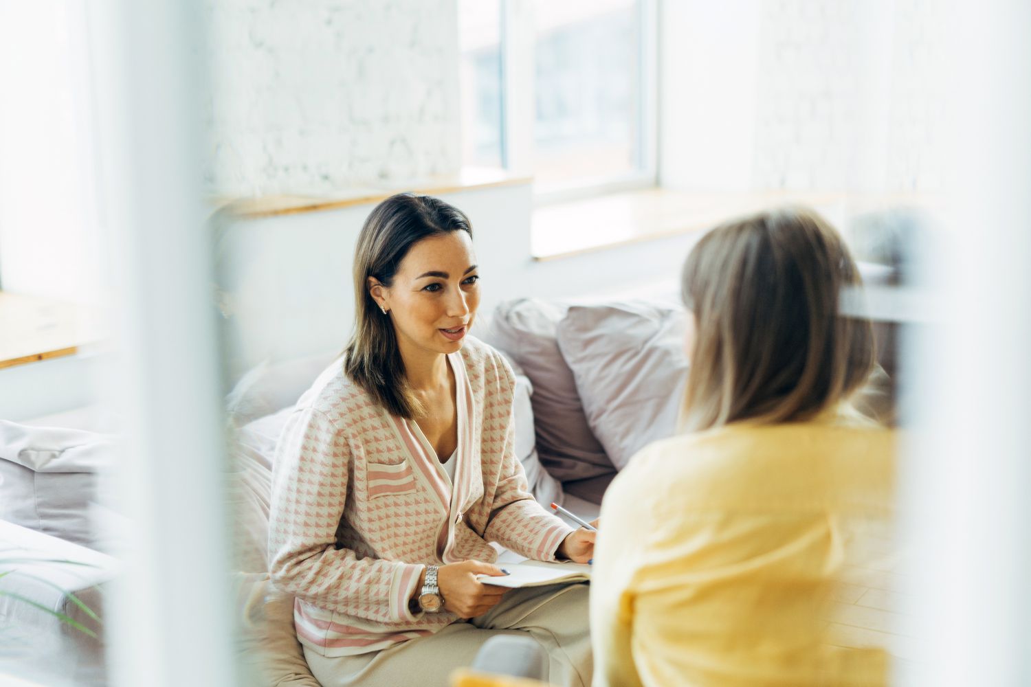 Female psychologist talk with patient in her office