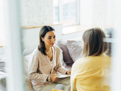 Female psychologist talk with patient in her office