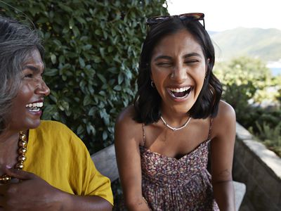 Cheerful female friends laughing together during weekend party