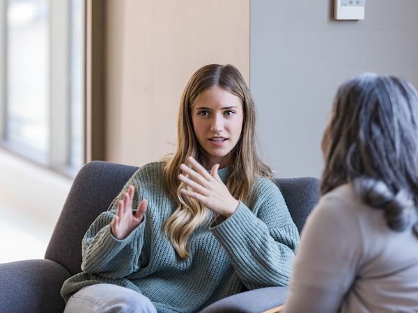 Young adult university student talks with her therapist