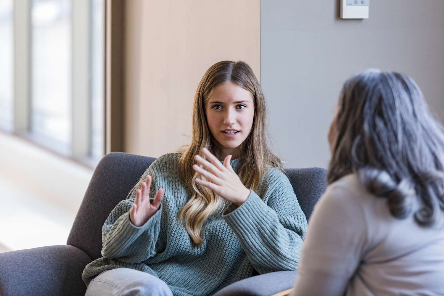 Young adult university student talks with her therapist