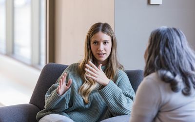 Young adult university student talks with her therapist