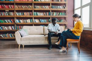 Young Black man talks with a female therapist