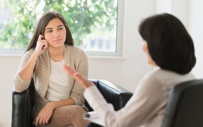 a teen in a counseling session with a therapist