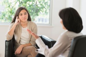 a teen in a counseling session with a therapist