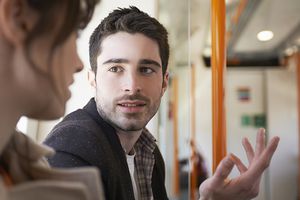 man talking to woman in train