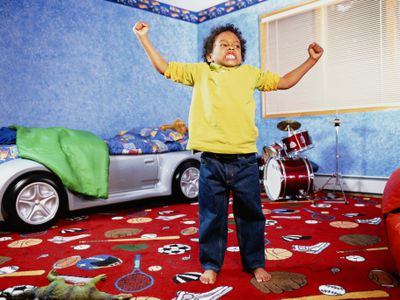 Boy (4-6) posing in bedroom, portrait