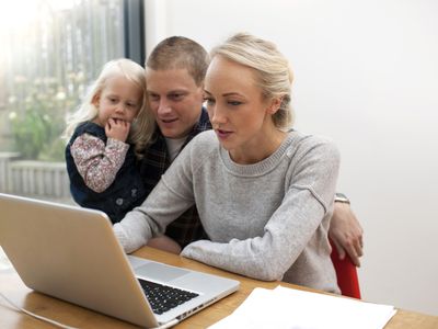 Family looking at laptop