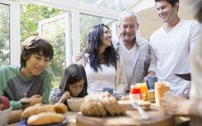 Multi-generation family eating in kitchen