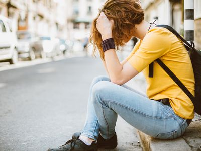 Sad teenage girl at the street