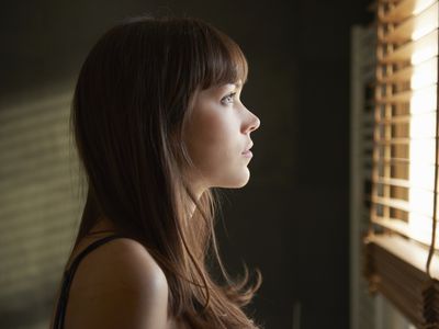 Young woman looking out of window 