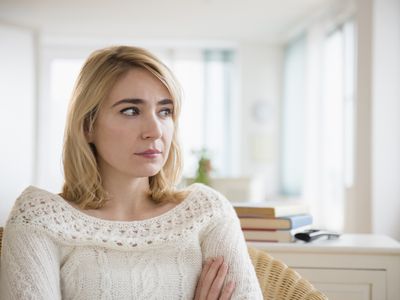 Lonely Caucasian woman sitting in living room