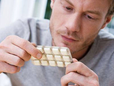 Man holding packet of nicotine gum