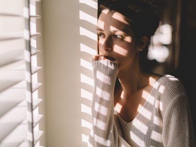 Sad woman looking through the window