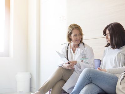 young woman and doctor talking