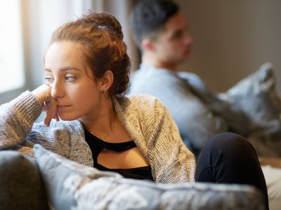 Shot of a young woman looking despondent after a fight with her boyfriend