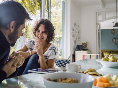 happy couple talking over breakfast