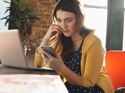 Stressed Caucasian businesswoman using cell phone