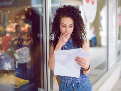 Portrait of a young woman getting the mail