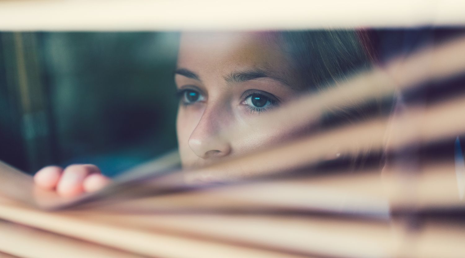 Woman staring out a window.