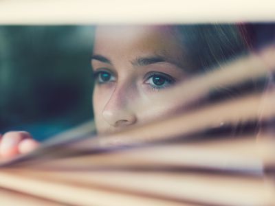 Woman staring out a window.