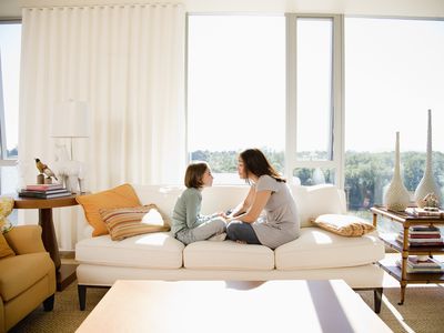 mother and daughter sitting on the couch together