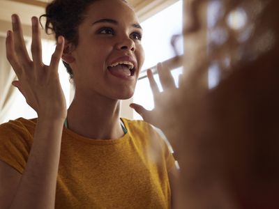 Close-up young women talking, while sitting in bunk bed