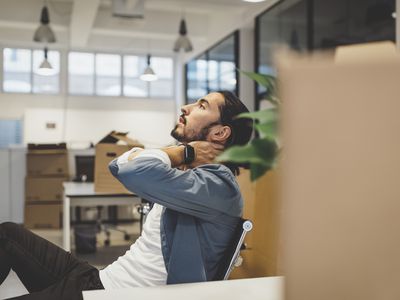 person sitting at their desk with neck pain stressed out