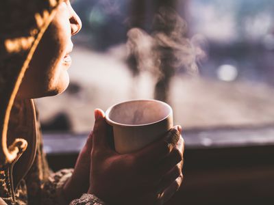 Woman Having coffee During Sunset