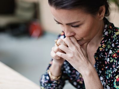 Close-up of tired thoughtful woman with arms