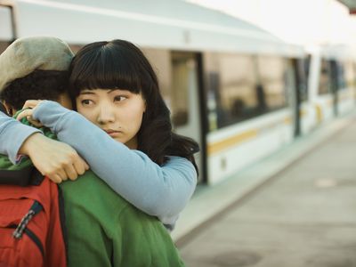 Couple hugging at a train station