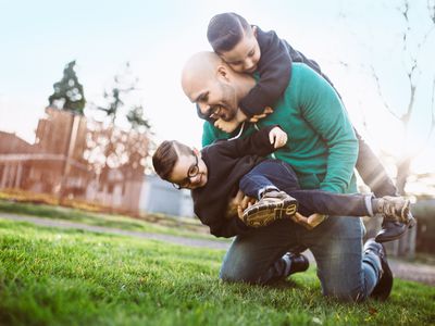 Dad playing with his kids outside