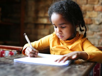 Girl writing on paper