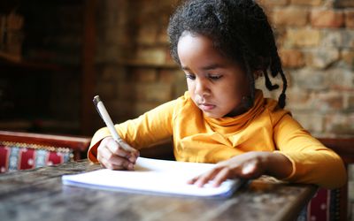 Girl writing on paper