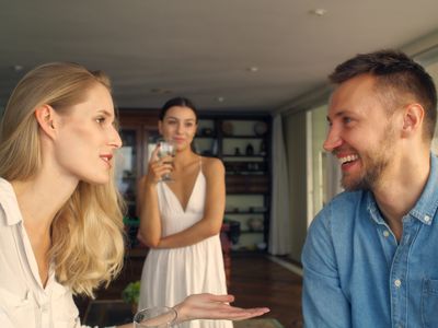 Man flirting with other woman in holiday villa