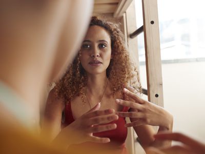 Black woman talking to someone, making hand gesture