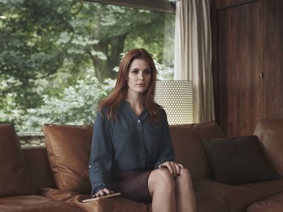 expressionless woman sitting on sofa