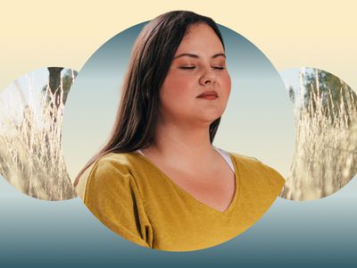 Woman closing her eyes meditating against a field backdrop