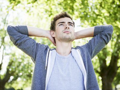 Thoughtful man with hands behind his head