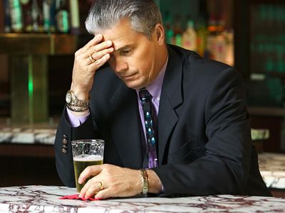 Downcast businessman in bar